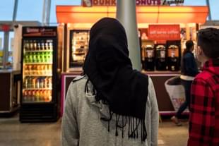 A young woman wearing a Hijab watches on. (Drew Angerer/Getty Images) 