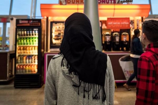 A young woman wearing a Hijab watches on. (Drew Angerer/Getty Images) 