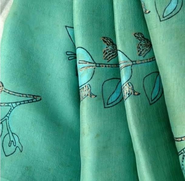The fabric wears the green dye of Patang.