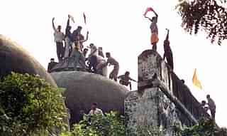 Hindu youth demolishing the disputed structure in Ayodhya. 