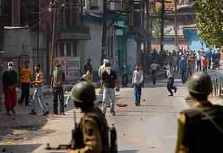 Kashmiri youth throw stones at the Indian military  in Srinagar. (Paula Bronstein/GettyImages)