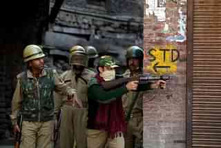Indian paramilitary forces watch and act against rock-throwing youths in Srinagar, Kashmir.