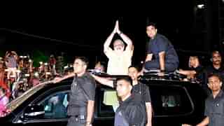 Prime Minister Modi gestures to his supporters during the road show in Surat on Sunday. (PTI)&nbsp;