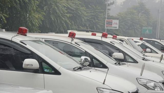 Government vehicles with red beacons. 