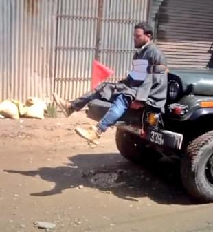 A stone pelter in the Kashmir valley tied to a vehicle.