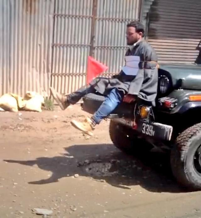 A stone pelter in the Kashmir valley tied to a vehicle. 