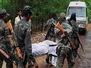 CRPF personnel carry an injured soldier.