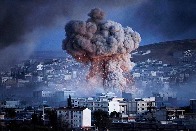 

An explosion rocks Syrian city of Kobani during a reported suicide car bomb attack by the militants of Islamic State (ISIS) group on a People’s Protection Unit (YPG) position in the city center of Kobani, as seen from the outskirts of Suruc, on the Turkey-Syria border, October 20, 2014 in Sanliurfa province, Turkey. According to Foreign Minister Mevlut Cavusoglu, Turkey will reportedly allow Iraqi Kurdish fighters to cross the Syrian border to fight Islamic State (IS) militants in the Syrian city of Kobani while the United States has sent planes to drop weapons, ammunition and medical supplies to Syrian Kurdish fighters around Kobani. (Photo by Gokhan Sahin/Getty Images)