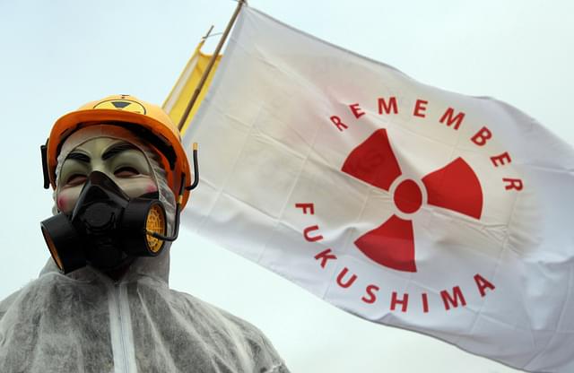 A masked protestor at the first anniversary of Fukushima (Matt Cardy / Getty Images)