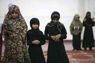 Muslim girls offer prayer. (Paula Bronstein/Getty Images)