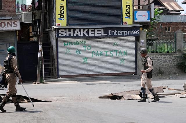

 Paramilitary soldiers stand guard during curfew in downtown area in Srinagar. (Waseem Andrabi/Hindustan Times via GettyImages)