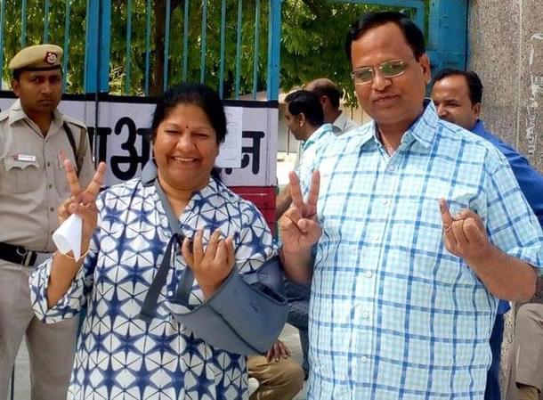 AAP’s Satyendra Jain with his wife in a polling booth in Saraswati Vihar