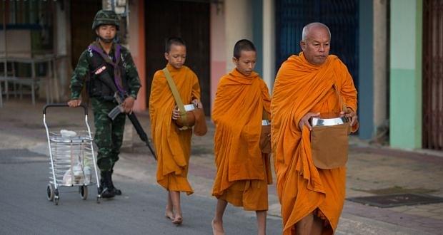 Buddhist monk seeks alms in southern Thailand.