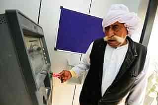 A villager uses an ATM machine to withdraw cash. (Priyanka Parashar/Mint via GettyImages) &nbsp;