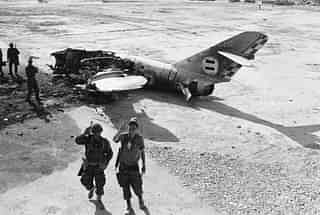 

Advancing Israeli troops pass the wreckage of an Arab warplane near El Arish Airport, during the Six-Day war. (Terry Fincher/Express/Getty Images)
