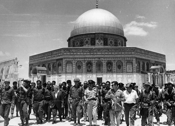 

Israel’s first prime minister David Ben-Gurion and the then Israel Defense Forces Chief Of Staff Yitzhak Rabin lead a group of soldiers past the ‘Dome of the Rock’ on the Temple Mount, on a victory tour following the Six Day War (Hulton Archive/Getty)
