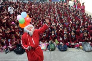 Children of St. Mary’s Convent Sr. Secondary School make merry with Santa at their school premises during the Christmas celebrations on December 23, 2015 in Bhopal, India. (Photo by Praveen Bajpai/Hindustan Times via Getty Images)