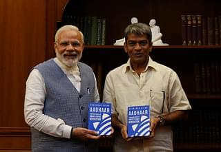 The author presents a copy of his book to Prime Minister Modi&nbsp;