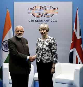 PM Modi meets British PM Theresa May on the sidelines of G-20 summit (<a href="https://twitter.com/MEAIndia/status/883645109199306752">MEA photo</a>)