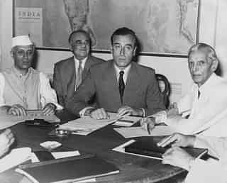 Nehru, left, and Jinnah, right, look on as Lord Mountbatten, centre, discloses Britain’s Partition plan for India. (Keystone/GettyImages)