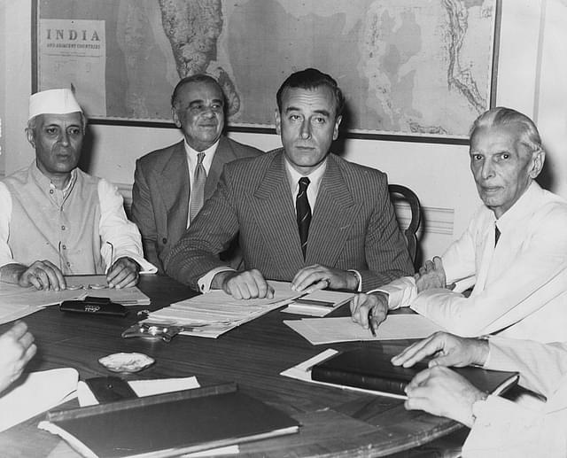 Nehru, left, and Jinnah, right, look on as Lord Mountbatten, centre, discloses Britain’s Partition plan for India. (Keystone/GettyImages)