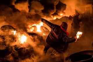An anti-government protester throws a Molotov cocktail during clashes with police in Kiev, Ukraine. (Brendan Hoffman/Getty Images)