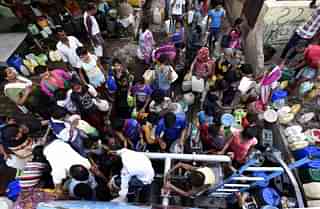 

People filling water from Delhi Jal Board water tank at Chanakyapuri (Sonu Mehta/Hindustan Times via Getty Images)