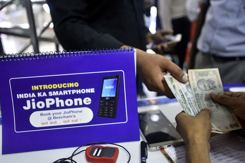 A customer at Reliance store for Jio phone pre-booking at Connaught Place in New Delhi. (Arun Sharma/Hindustan Times via GettyImages) &nbsp;