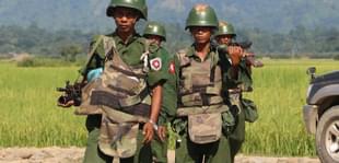 Myanmar soldiers patrol a village in Maungdaw located in Rakhine State. (STR/AFP/Getty Images)