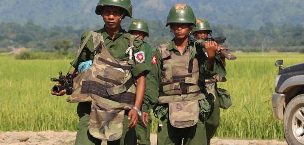 Myanmar soldiers patrol a village in Maungdaw located in Rakhine State. (STR/AFP/Getty Images)