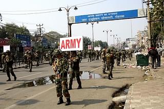 Army personnel take out a flag march to handle the situation as Jat community protests on the roads demanding reservations in government services on 20 February 2016 in Rohtak, India. (Manoj Dhaka/Hindustan Times via GettyImages)