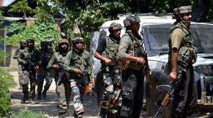 Jawans take position outside a house where militants were hiding.