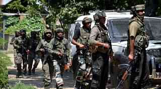
Jawans take position outside a house where militants were hiding.

