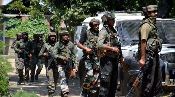 Jawans take position outside a house where militants were hiding.