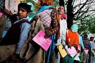 People waiting to get ration from public distribution system (PDS) outlet in village Khedla in Haryana. (Priyanka Parashar/Mint via Getty Images)