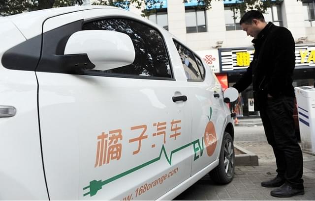  A man charging an electric vehicle at a station in Linan, east China’s Zhejiang province. (Stringer/AFP/Getty Images)

