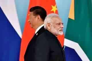 Chinese President Xi Jinping (L) and Prime Minister Narendra Modi at the group photo session during the BRICS Summit in China. (KENZABURO FUKUHARA/AFP/Getty Images)