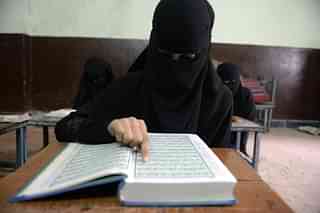 A Muslim Girl in India studies the Quoran (NOAH SEELAM/AFP/Getty Images)