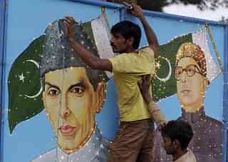 A Pakistani man decorates with a portrait country’s founder, Mohammad Ali Jinnah, ahead of the country’s Independence Day in Quetta. (BANARAS KHAN/AFP/Getty Images)