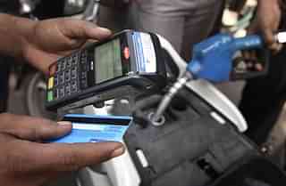  The people using debit card to pay for the petrol at Petrol Pump in Mayur Vihar on November 9, 2016 in New Delhi, India. In a surprise announcement late Tuesday, Prime Minister Narendra Modi banned 500 rupee ($7.50) and 1,000 rupee notes effective midnight, sweeping away 86 percent of total currency in circulation. In panic people flocked to their nearest ATMs, Petrol Pumps and Railway Stations to get change cash. (Sushil Kumar/Hindustan Times via Getty Images)