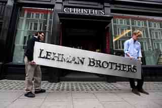 Two employees of Christie’s auction house manoeuvre the Lehman Brothers corporate logo, which is estimated to sell for 3000 GBP and is featured in the sale of art owned by the collapsed investment bank Lehman Brothers on September 24, 2010 in London, England. (Oli Scarff/Getty Images)