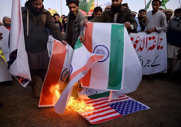 Pakistani supporters of the Jamaat-ud-Dawa organisation burn Indian and US flags Islamabad. (AAMIR QURESHI/AFP/Getty Images)