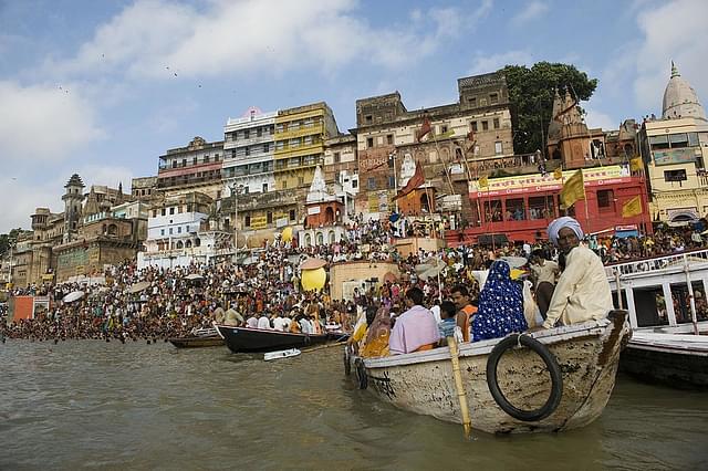 Indian tourists take a ride on a boat in Varanasi. (PRAKASH SINGH/AFP/GettyImages)