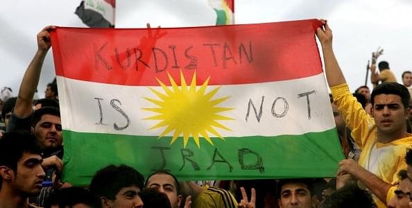 Iraqi Kurdish football 
fans holding a Kurdistan flag. SAFIN HAMED/AFP/Getty Images)


