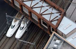 A pair of Shinkansen trains are seen under a pedestrian overbridge in Tokyo. (TORU YAMANAKA/AFP/Getty Images)