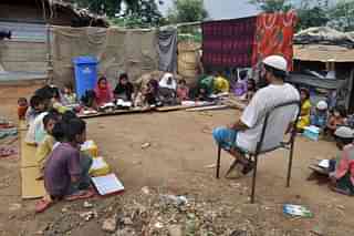  Rohingya Muslim refugee children from Myanmar study at a makeshift madrasa (religious school) on World Refugee Day in the outskirts of the Indian city Jammu on June 20, 2017. Hundreds of thousands of Muslim Rohingya have fled from Myanmar in recent decades, escaping persecution from the Buddhist-majority nation for generations. (AFP/Getty Images)