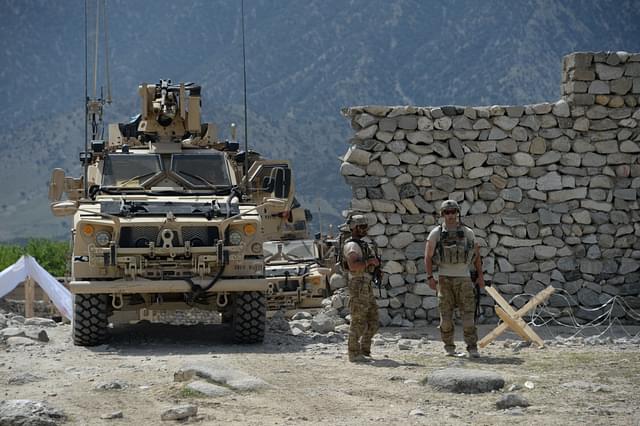 US soldiers patrol near the site of a 
US bombing during an operation against Islamic State (IS) militants in 
the Achin district of Afghanistan’s Nangarhar province. (NOORULLAH SHIRZADA/AFP/Getty Images)

