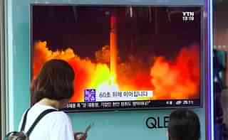 People watch a TV screen showing a video footage of North Korea’s latest test launch of an intercontinental ballistic missile (ICBM). (JUNG YEON-JE/AFP/Getty Images)