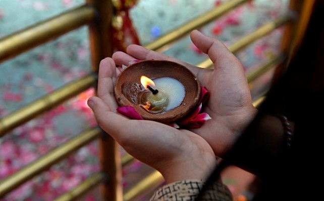 A Kashmiri Pandit offers prayers during the annual Hindu festival at the Khirbhawani temple in the village of Tullamulla, east of Srinagar. (TAUSEEF MUSTAFA/AFP/Getty Images)