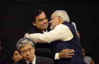 Narendra Modi (R) greets Reliance chairman and managing director Mukesh Ambani. (SAM PANTHAKY/AFP/Getty Images)